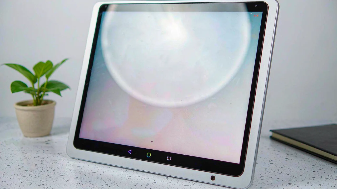 Android tablet on a desk showing a settings panel with signal bars
