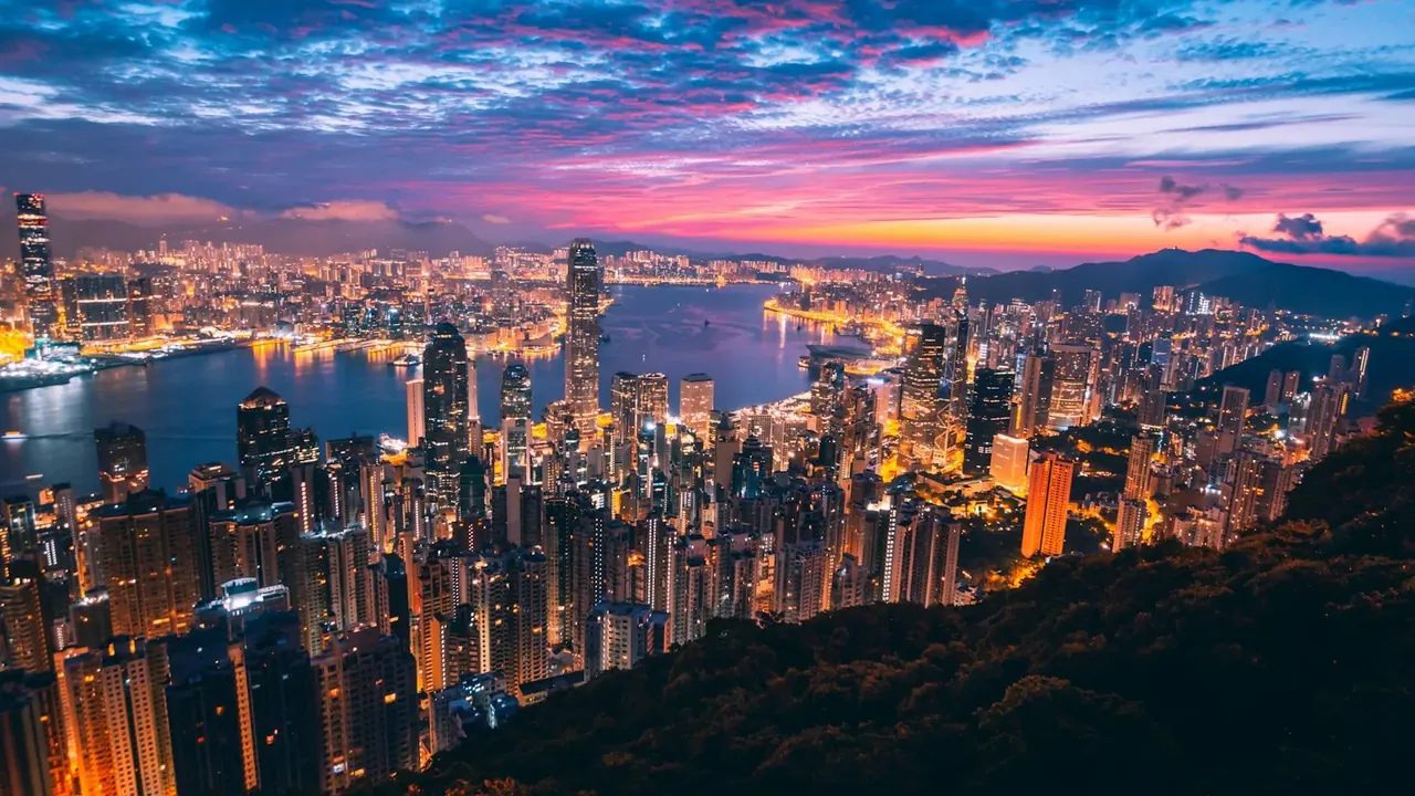 Hong Kong island skyline across Victoria Harbour at dusk