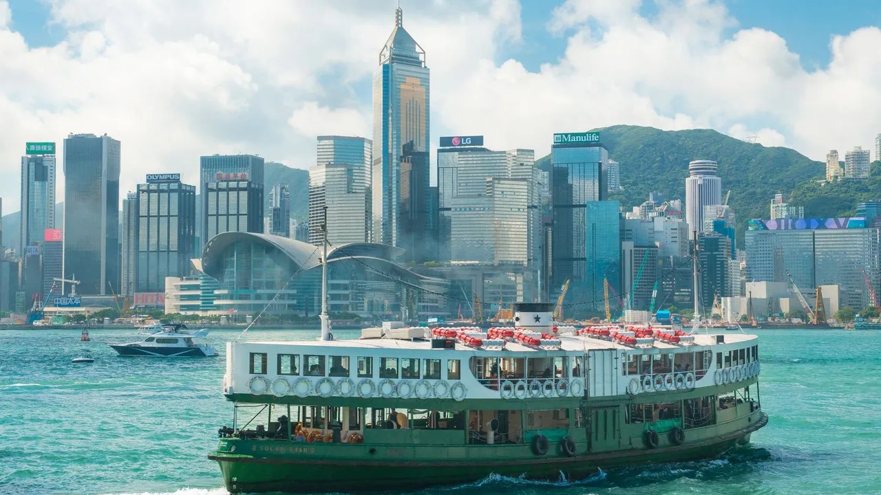 Star Ferry crossing Victoria Harbour with the Hong Kong Island skyline behind