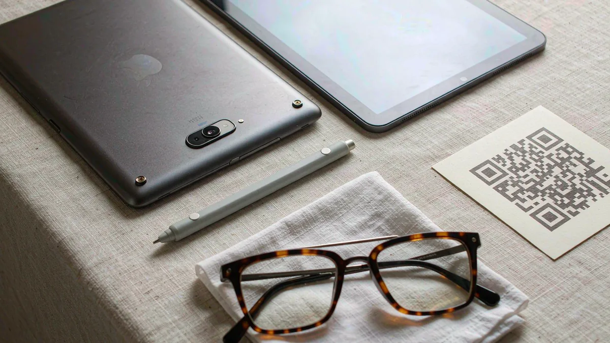 Tablet flat-lay with stylus, sunglasses and an eSIM QR code