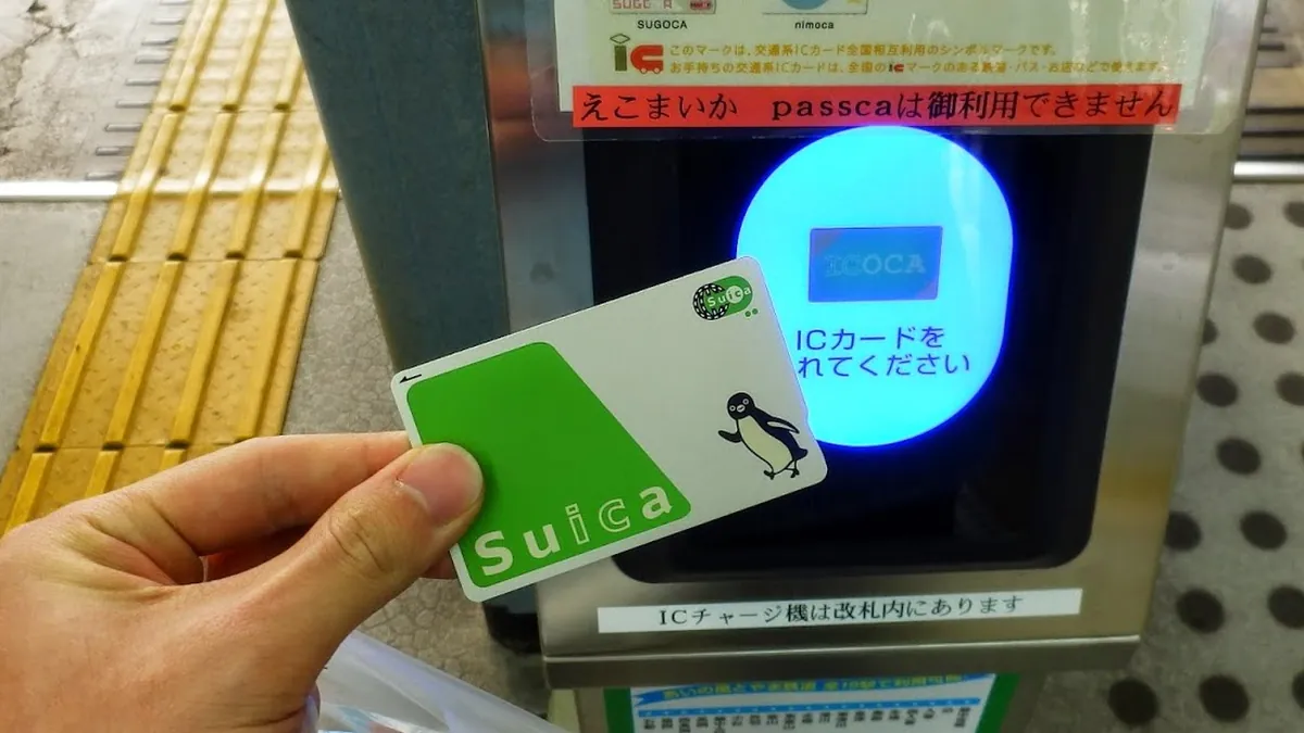 Tapping a Suica card on a station ticket gate
