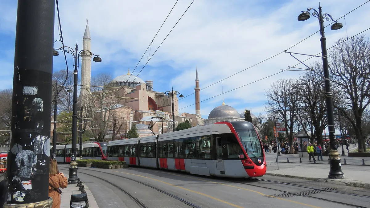 Istanbul T1 tram passing Sultanahmet square with Hagia Sophia behind
