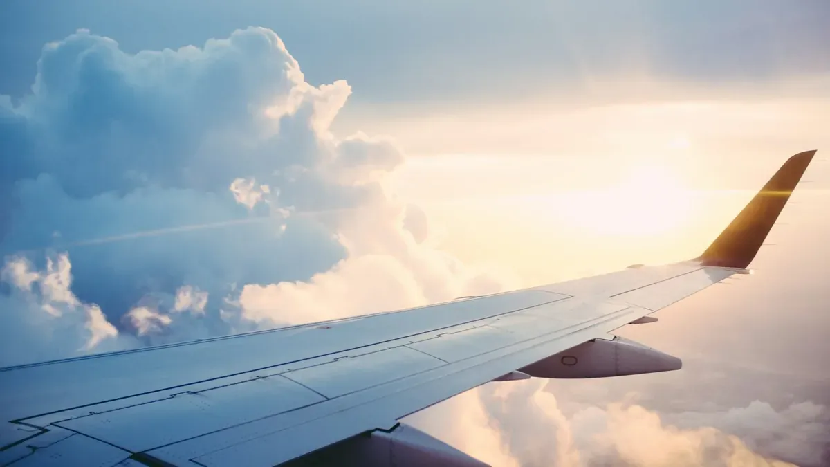 Wing of a plane descending toward the United States